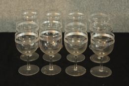 A set of twelve early 20th century wine glasses with acid etched decoration. H.12cm. (each)