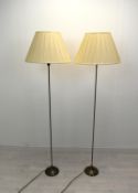 A contemporary pair of slender brass standard lamps raised on stepped circular bases. H.158cm