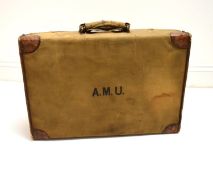 An early 20th century canvas covered crocodile skin effect gentlemen's vanity case embossed with