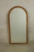 A 20th century arch topped gilt framed mirror. H.90 W.44cm.