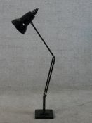 A vintage anglepoise lamp raised on square base with anglepoise patent stamp.