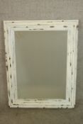An early 20th century white painted mahogany framed rectangular wall mirror. H.90 W.70cm.