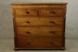 A 19th century mahogany chest of two short over three long drawers, with turned knob handles