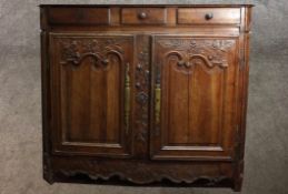 A 19th/early 20th century mahogany French style sideboard with three drawers above twin cupboard