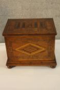 A 19th century inlaid walnut minature blanket box, the hinged lid opening to reveal a candlebox,