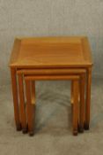 A mid 20th century nest of three G-Plan style teak intersliding tables. H.48 W.48 D.42cm. (largest)