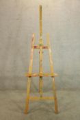 A 20th century pine floor standing artists easel raised on three splayed supports.