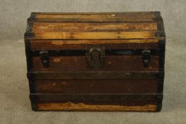 A 20th century dome topped twin handled travelling trunk, with various books and newspapers. H.47