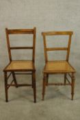 Two early 20th century walnut framed cane seated bedroom chairs raised on turned supports.