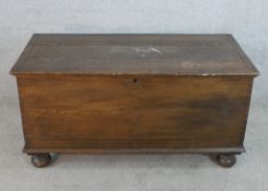 A 19th century oak inlaid blanket box raised on ball feet. H.52 W.105 D.50cm.