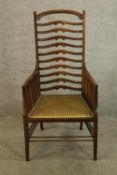 A 19th century Arts & Crafts mahogany ladder back armchair, the high arched back with ten splats and