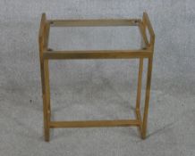 A contemporary brass framed and glass topped twin handled table. H.51 W.44 D.30cm