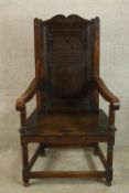 A 19th century carved beech Wainscott style open arm chair raised on turned supports and stretchers.