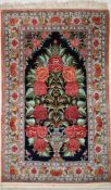 A contemporary Iranian/Persian silk Qum (Qom) tree of life design rug, the central black field