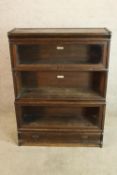 An early 20th century oak Globe Wernicke four tier sectional glazed bookcase with open and over