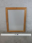 A contemporary stripped pine rectangular wall mirror. H.83 W.61cm