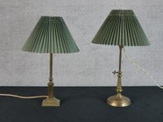 An early 20th century adjustable brass table lamp raised on circular foot, together with a brass