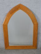 A contemporary pine framed Gothic arched wall mirror. H.106 W.78cm