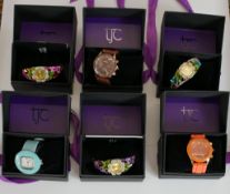 A collection of six new in the box Strada fashion watches each with a different design. H.8 W.10 D.