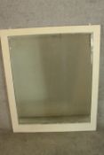 An early 20th century white painted wall hanging mirror. H.108 88cm.