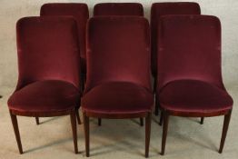 A set of six mid 20th century mahogany framed red upholstered dining chairs raised on tapering