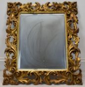 A late 19th/early 20th century rectangular Italian style carved gilt framed wall hanging mirror. H.