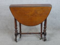 A late 19th century mahogany Sutherland drop leaf occasional table raised on turned supports