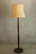 A 20th century mahogany standard lamp raised on circular feet. H.170cm.