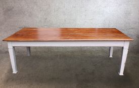 A C.1900 painted pine kitchen table raised on tapering supports terminating in pad feet. H.76 W.