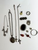 A collection of silver and costume jewellery, including a Victorian silver coin brooch, an amber