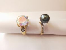 Two 20th century 14 carat gold gem-set rings: a mystic topaz flanked solitaire ring and a cross over