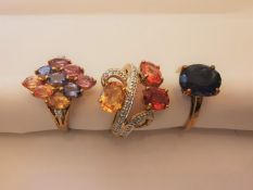 Three 20th century 9 carat yellow gold gem-set rings: an Iolite solitaire ring set with an oval