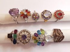 A collection of ten silver and gold plated silver dress rings set with various gemstones,