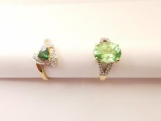 Two 20th century 18 carat yellow gold gem-set rings: a flanked solitaire dress ring set with a green