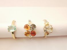 Three 20th century 10 carat gold gem-set rings: a Praisolite and diamond flanked solitaire ring,