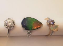 Three 20th century 10 carat yellow gold gem-set rings: a drop shape ammolite triplet cabochon