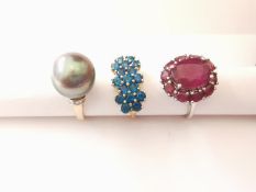 Three 20th century 10 carat gold gem-set rings: a ruby cluster ring set to centre with a oval