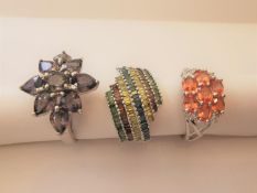 Three 20th century 9 carat and 10 carat white gold gem-set rings: a coloured diamond dress ring, a