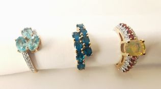 Three 20th century 10 carat yellow gold gem-set rings: a water opal, tourmaline and white topaz