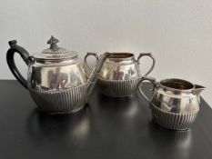 A Victorian three piece sterling silver gadrooned tea set to include tea pot, sugar bowl and milk