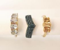Three 20th century 10 carat gold gem-set rings: a blue diamond V-shaped band set with 90 single