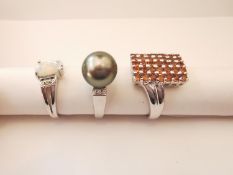 Three 20th century 9 carat white gold gem-set rings: a black cultured pearl and diamond dress
