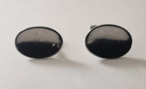 A pair of cotemporary 18 carat white gold concave oval disk stud earrings with butterfly fittings.