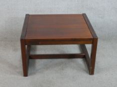 A 20th century mahogany low square topped coffee table raised on square supports. H.37 W.61 D.61cm