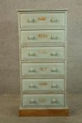 A Victorian style painted pine chest of six short drawers with turned knob handles raised on block
