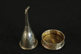 An early 20th century silver plated strainer, together with a Georgian style silver plated bottle