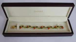 A boxed Iliana gold plated silver fashion bracelet set with peridot and amethyst in a floral design,