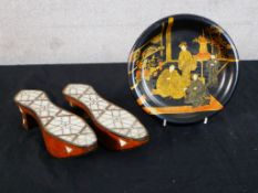 A 20th century Chinese lacquer plate decorated with men sitting on a carpet, together with a pair of
