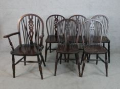 A set of six 20th century stained beech wheel and spindle back Windsor type dining chairs
