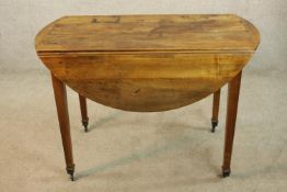 A 19th century French chestnut drop flap table raised on square tapering supports terminating in